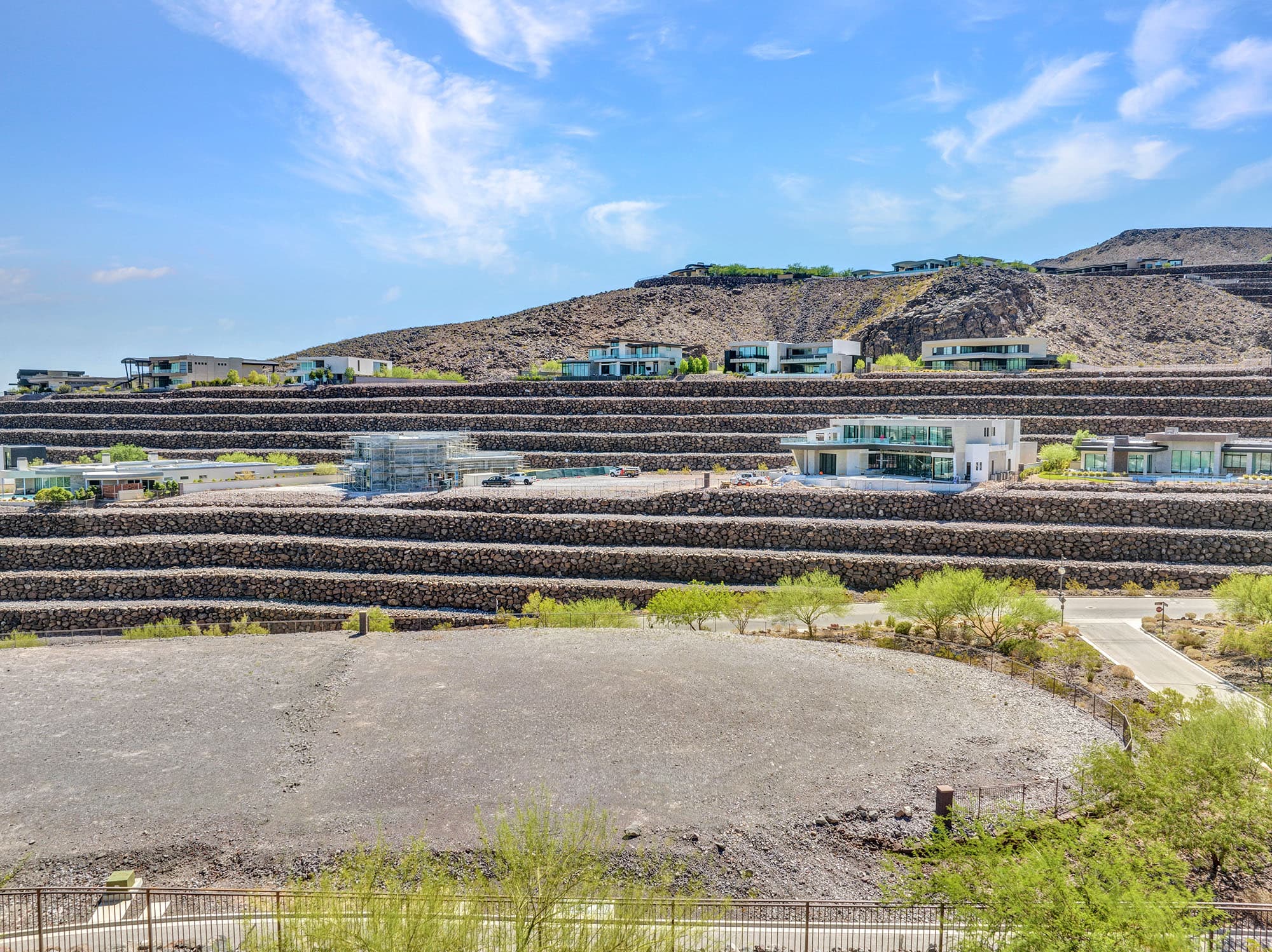 View from the homesite across Ascaya’s mountainside community, highlighting modern desert architecture and distinctive rockery terraces