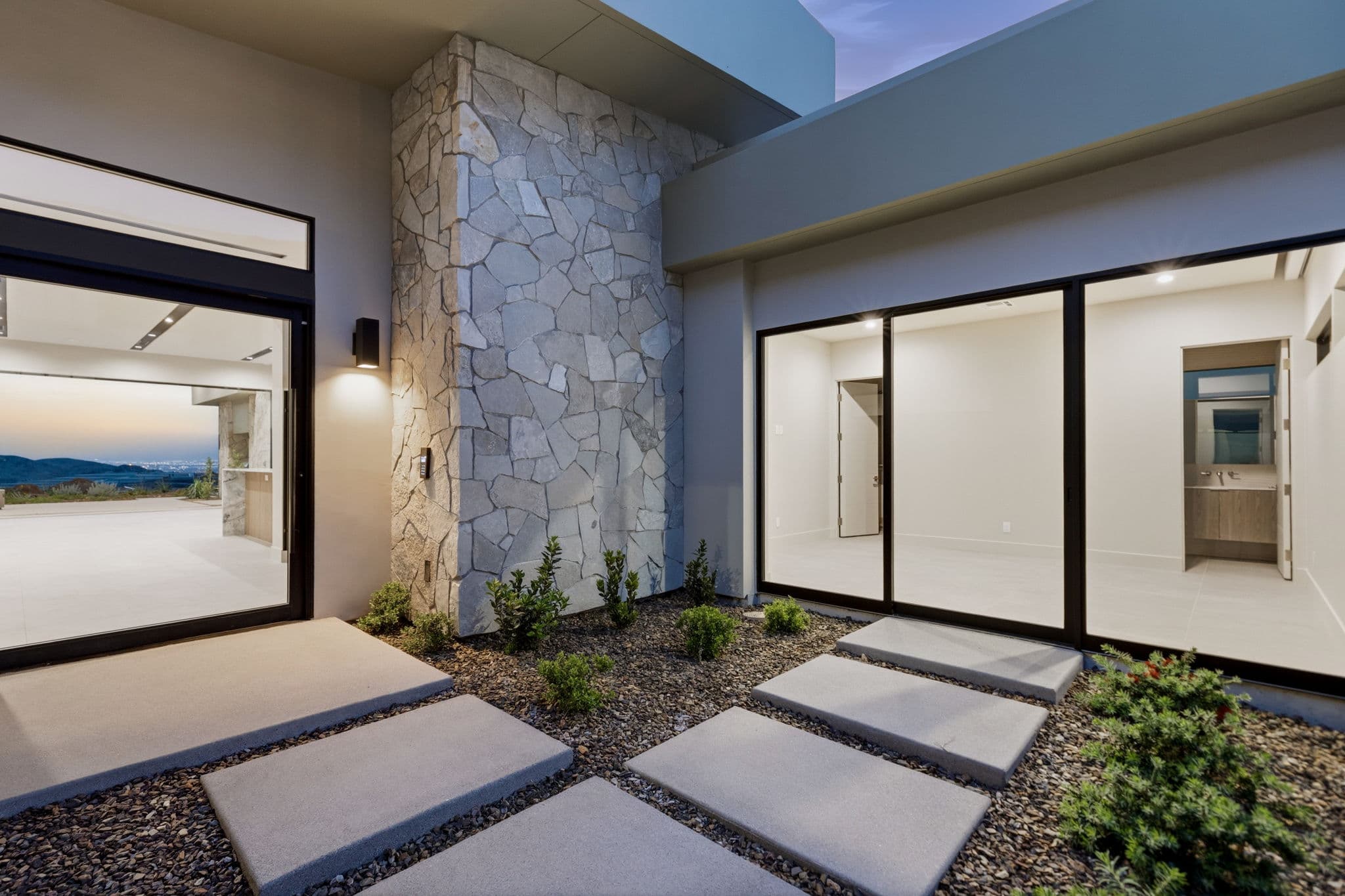Modern luxury residence with contemporary architecture, open-concept living spaces, high-end finishes, expansive windows, and seamless indoor-outdoor design set against scenic desert mountain views.