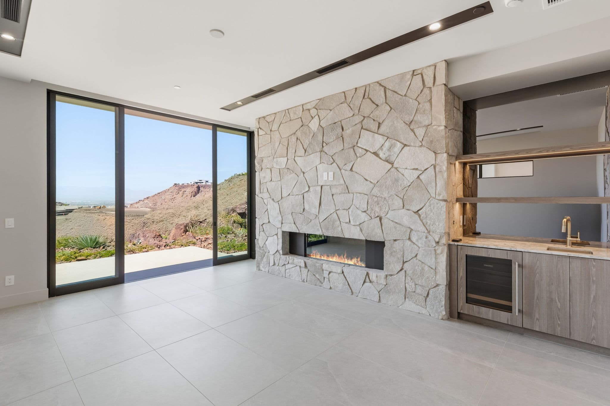 Modern luxury residence with contemporary architecture, open-concept living spaces, high-end finishes, expansive windows, and seamless indoor-outdoor design set against scenic desert mountain views.