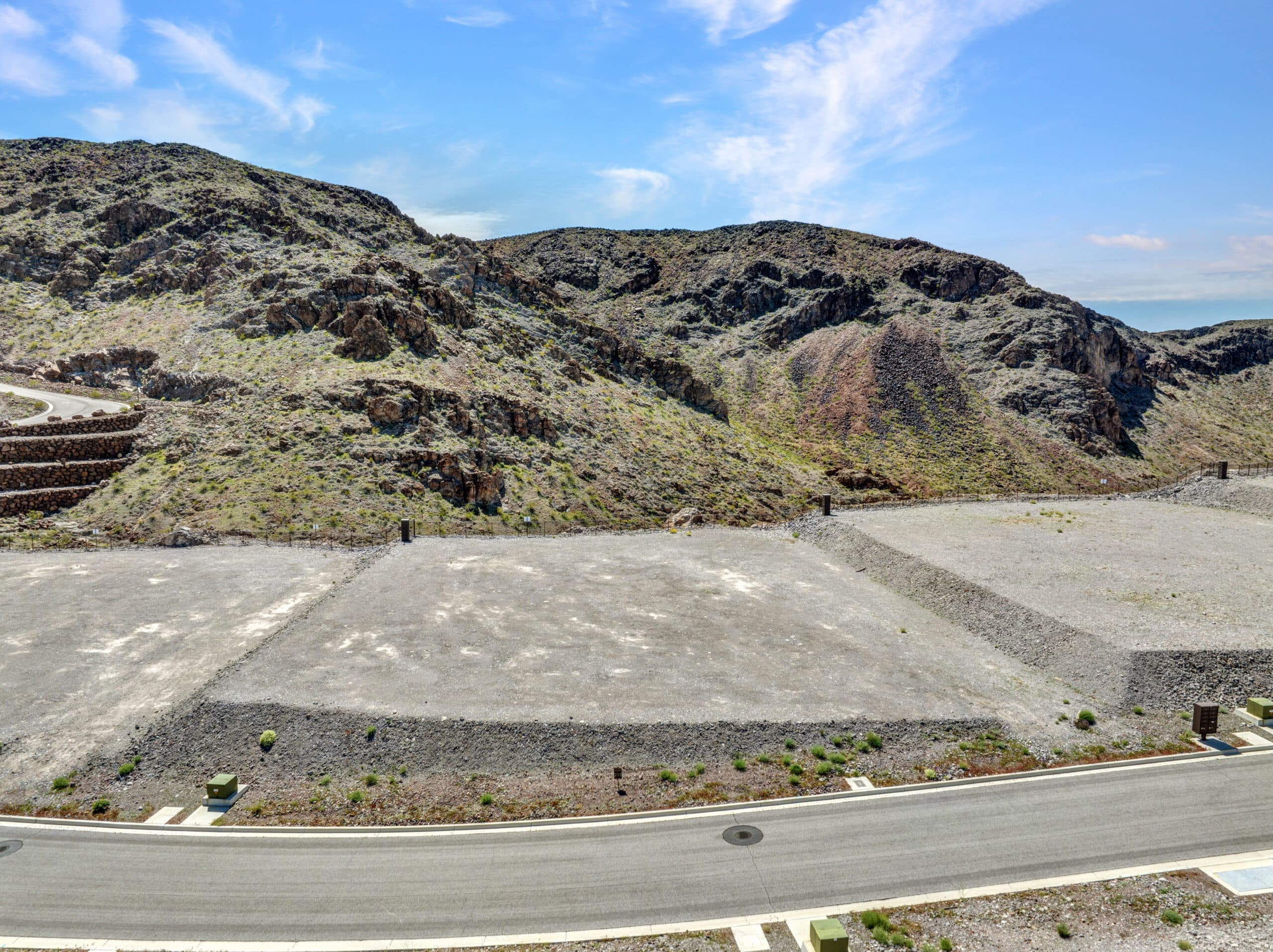 Private canyon-view homesite with terraced desert landscaping and sweeping mountain scenery in an exclusive Las Vegas luxury neighborhood.
