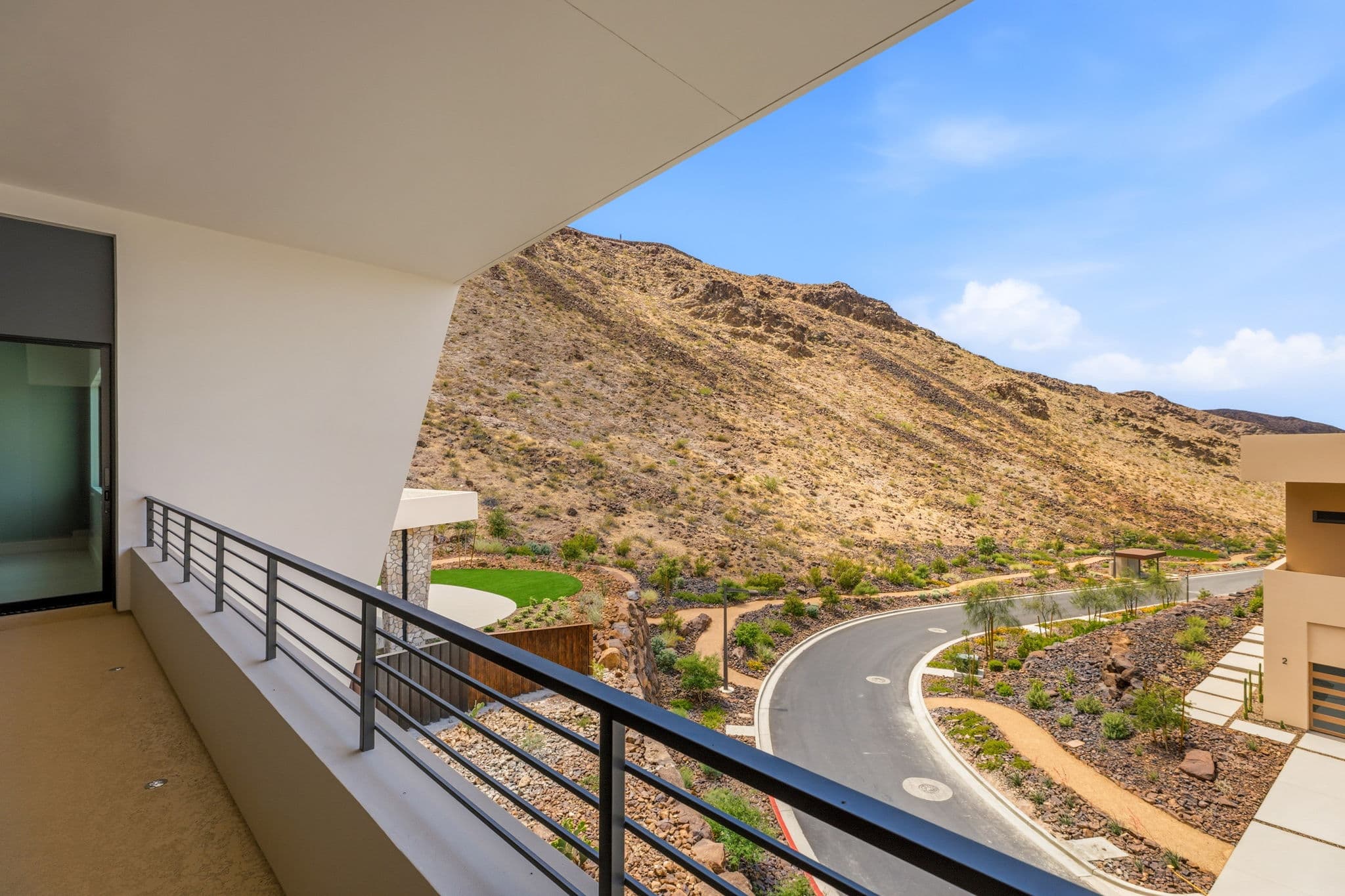 Modern luxury residence with contemporary architecture, open-concept living spaces, high-end finishes, expansive windows, and seamless indoor-outdoor design set against scenic desert mountain views.