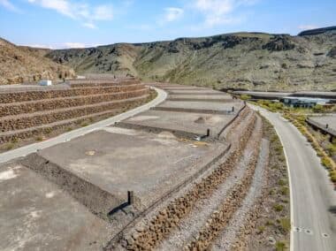 Aerial view of homesite lot outlined within a desert mountainside community development