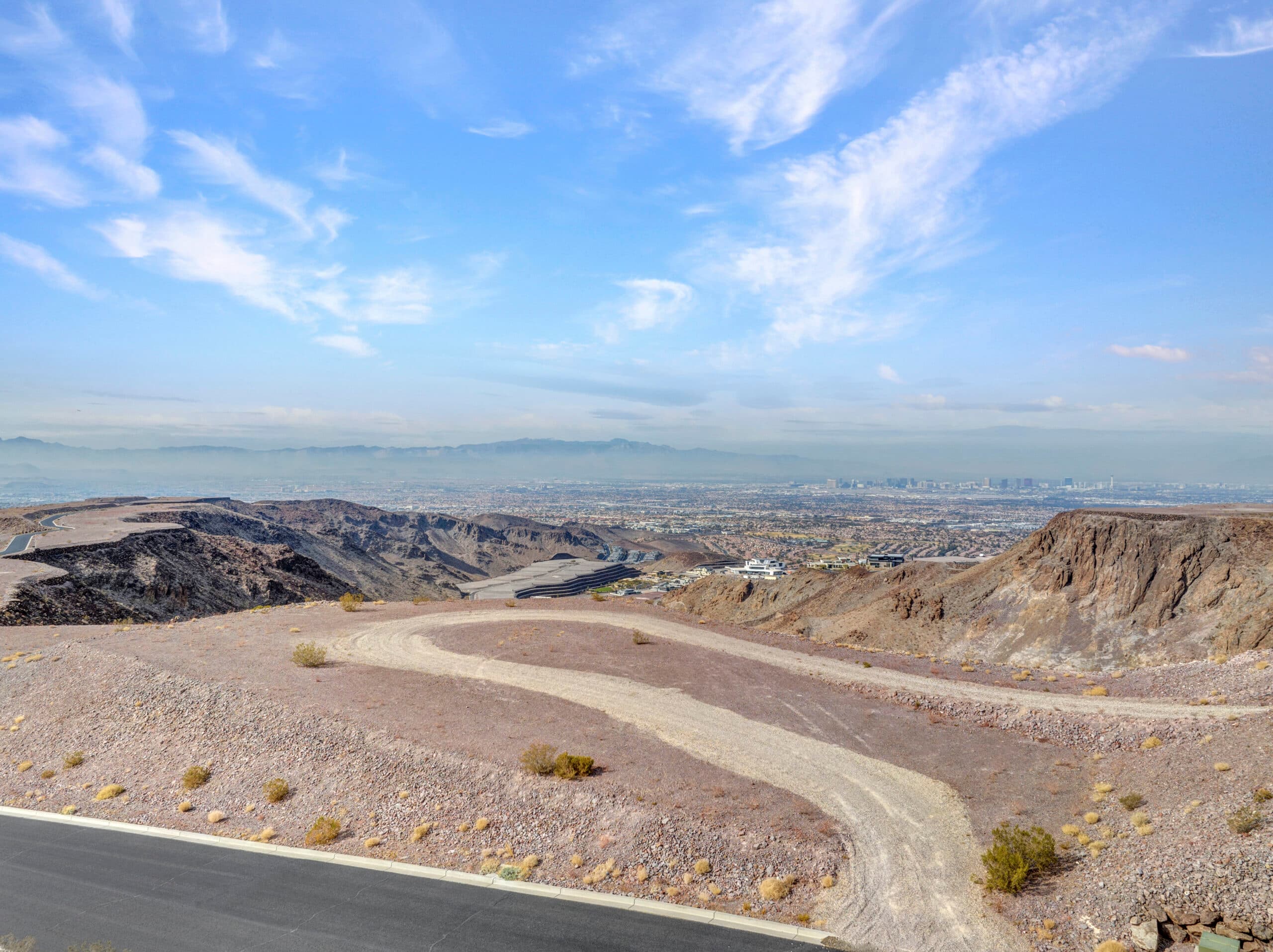 Panoramic Las Vegas Strip and mountain views from a premium desert hillside homesite in an exclusive luxury community.