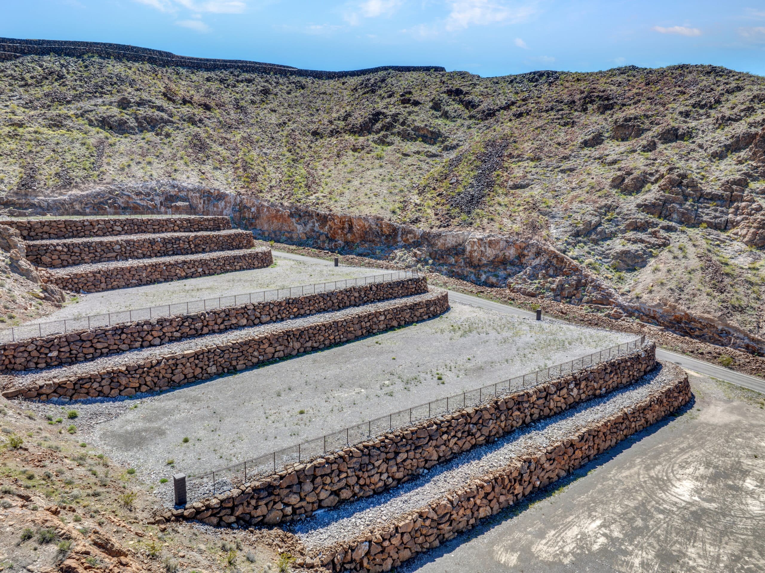 Terraced luxury homesite with stone retaining walls in desert hillside community near Las Vegas.