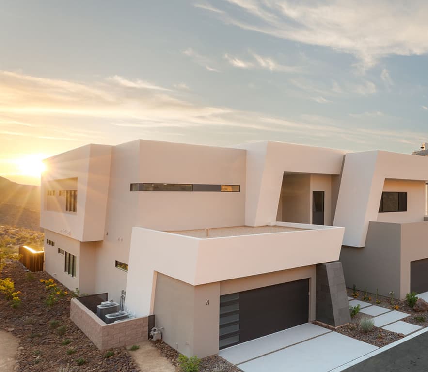 Contemporary desert residence with bold geometric architecture, private two-car garage, and warm sunset views at The Canyon Residences within Ascaya