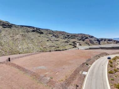 Aerial view of homesite lot outlined within a desert mountainside community development