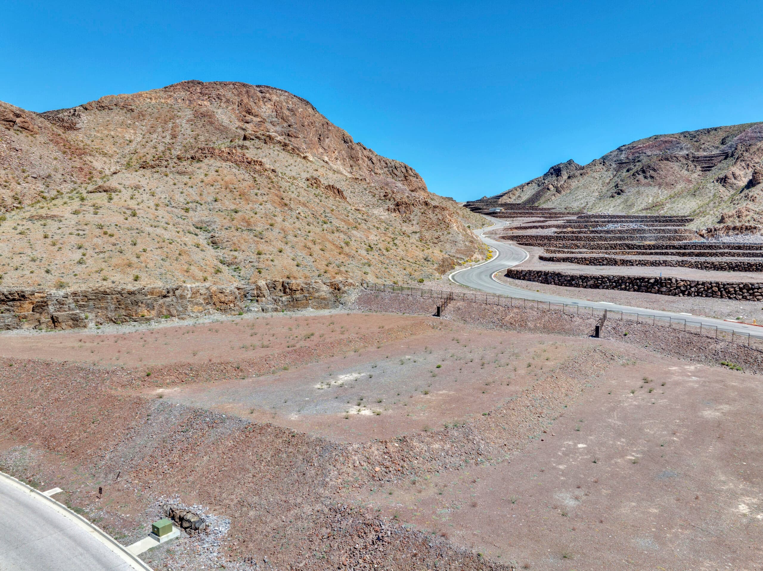 Sweeping desert canyon homesites with terraced lots and panoramic mountain views in an exclusive Las Vegas luxury community.