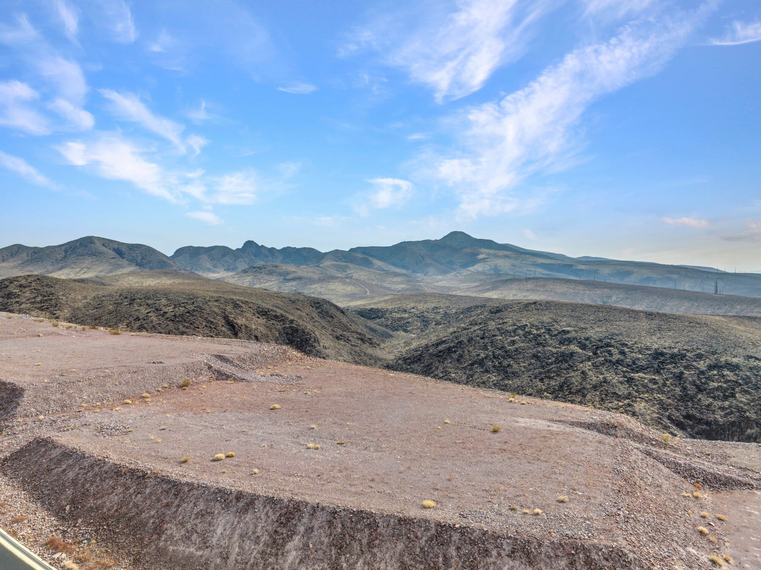 Elevated desert homesite with sweeping Las Vegas valley and mountain views in luxury hillside community.