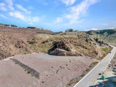 Aerial view of homesite lot outlined within a desert mountainside community development