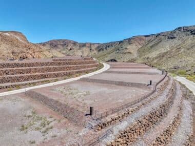 Aerial view of homesite lot outlined within a desert mountainside community development