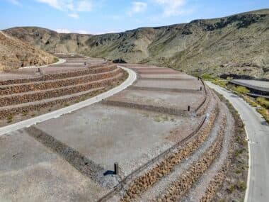 Aerial view of homesite lot outlined within a desert mountainside community development