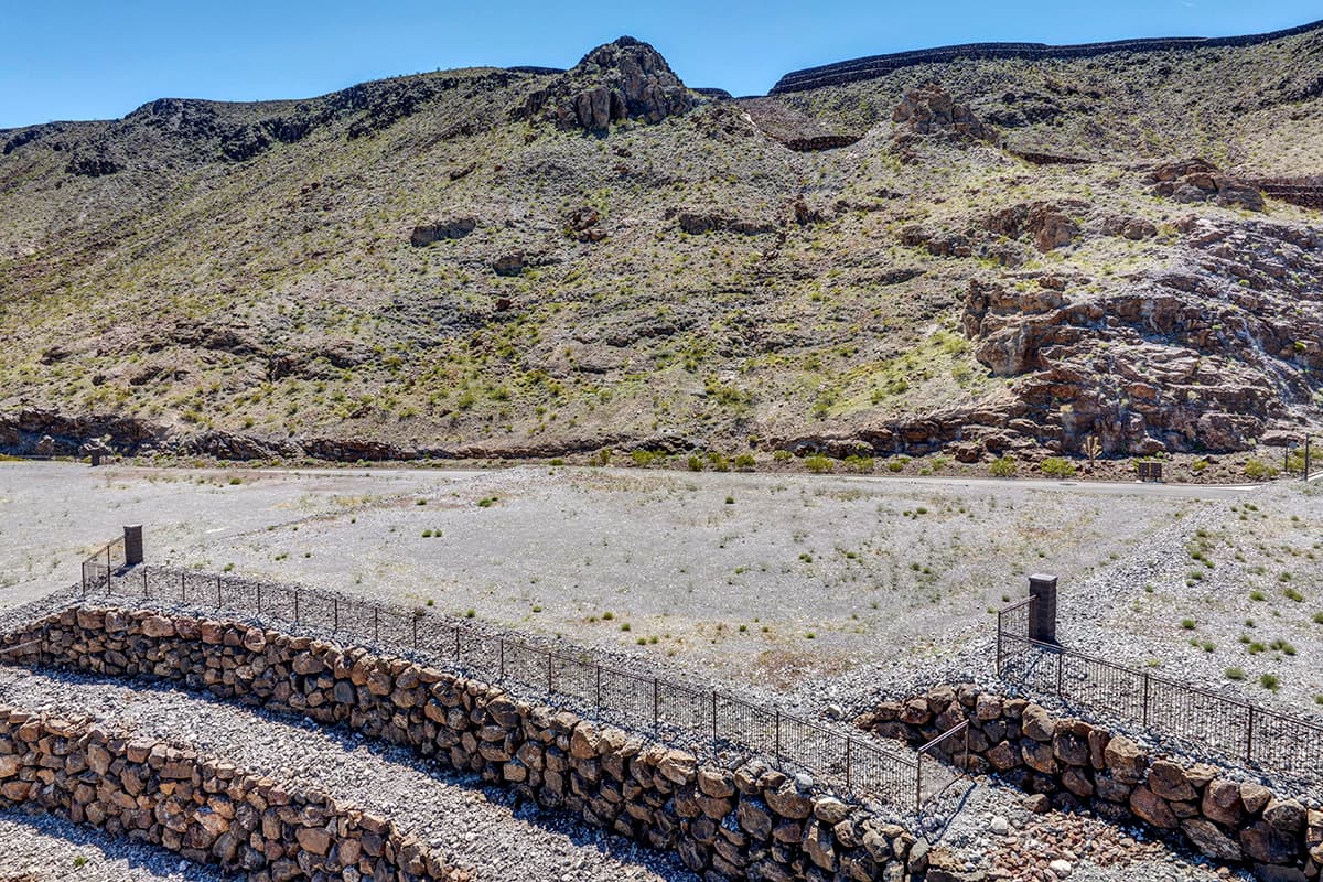 Elevated custom homesite with terraced retaining walls and dramatic desert mountain views in a luxury Las Vegas residential community.
