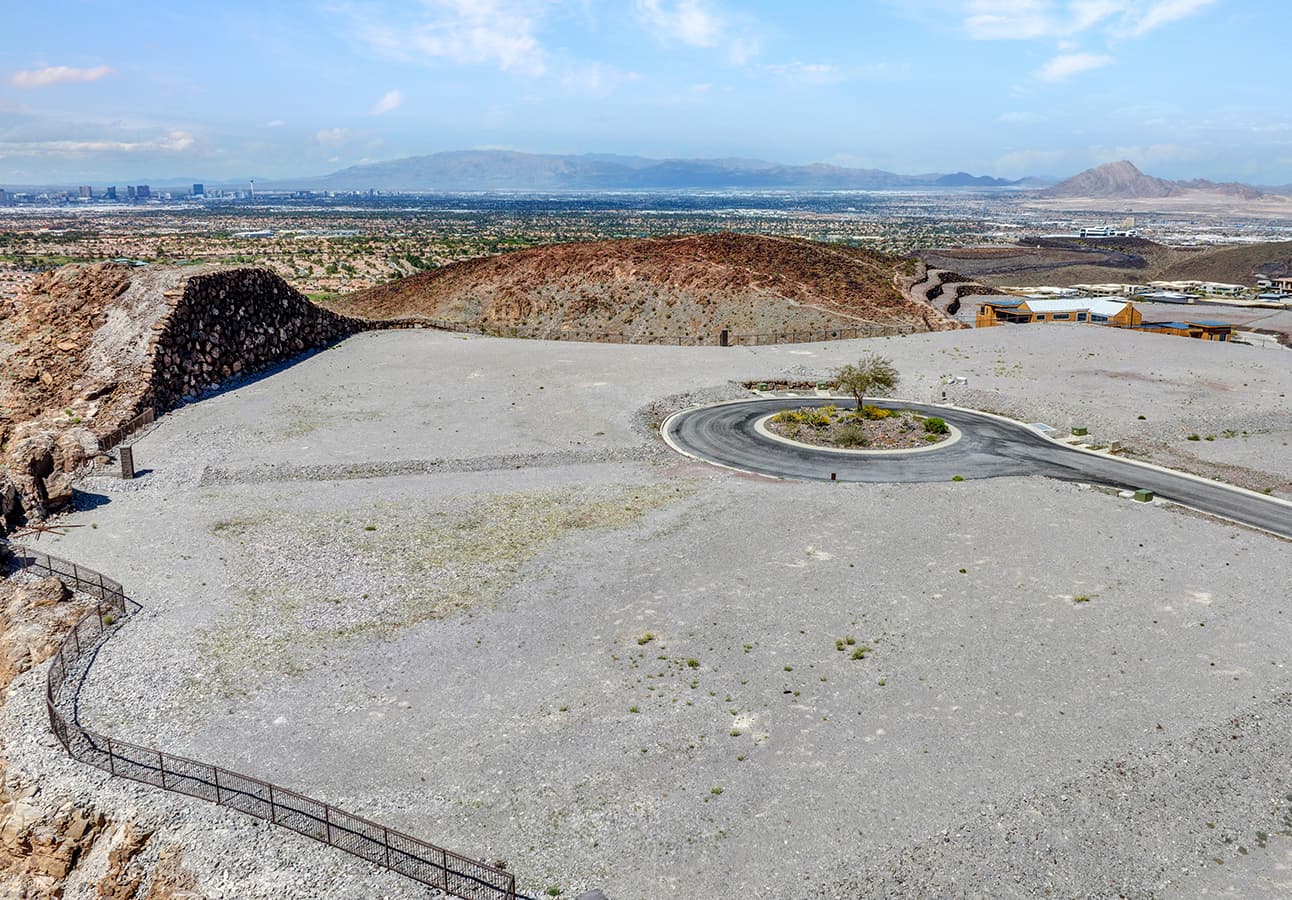 Expansive elevated homesite with private cul-de-sac access, sweeping Las Vegas skyline views, and dramatic desert mountain surroundings