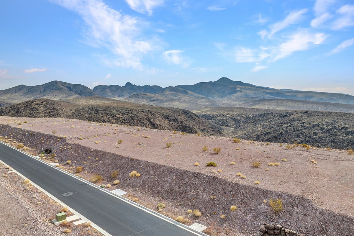 Elevated desert homesite with sweeping Las Vegas valley and mountain views in luxury hillside community.