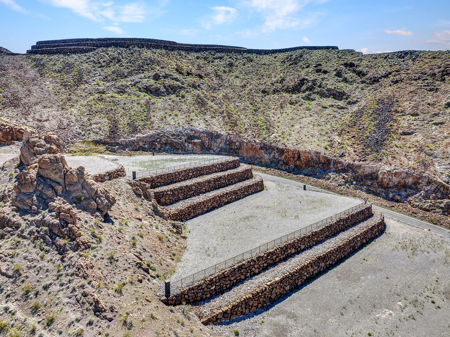 Terraced luxury homesite with stone retaining walls in desert hillside community near Las Vegas.