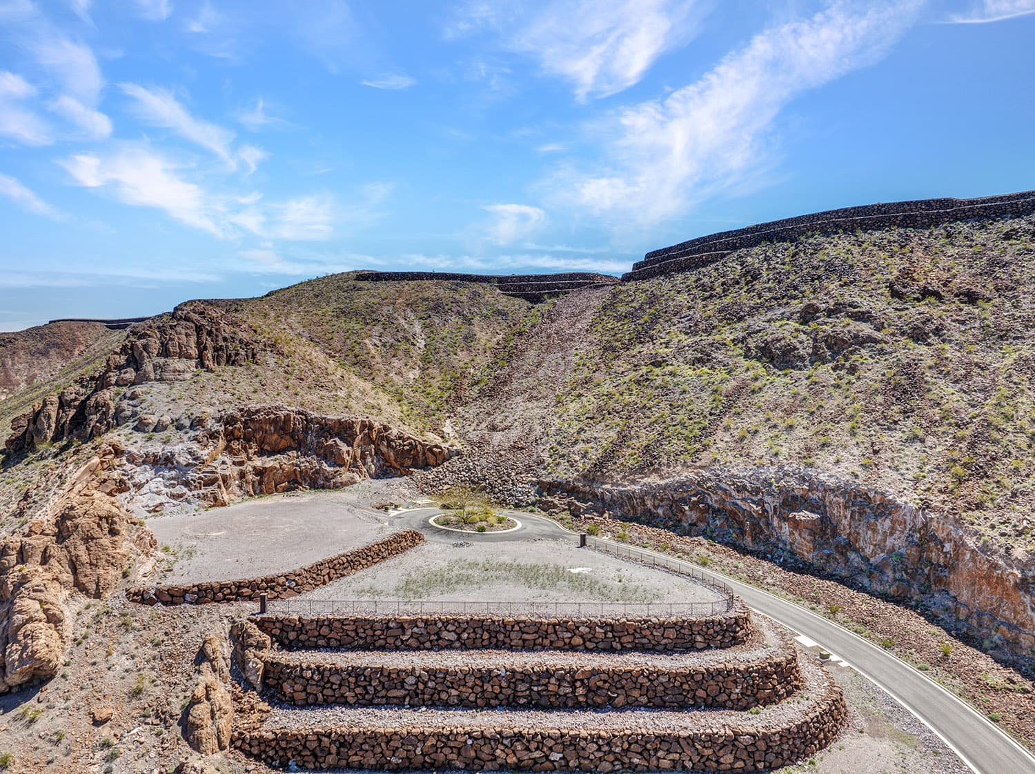 Terraced luxury homesite with stone retaining walls in desert hillside community near Las Vegas.