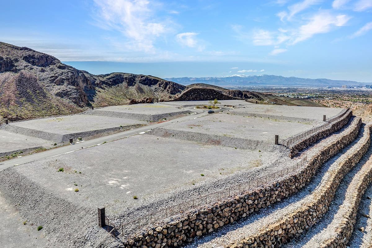 Elevated custom homesite with terraced retaining walls and dramatic desert mountain views in a luxury Las Vegas residential community.