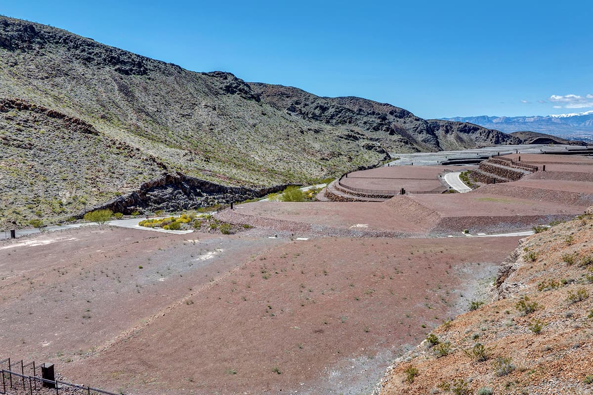 Sweeping desert canyon homesites with terraced lots and panoramic mountain views in an exclusive Las Vegas luxury community.