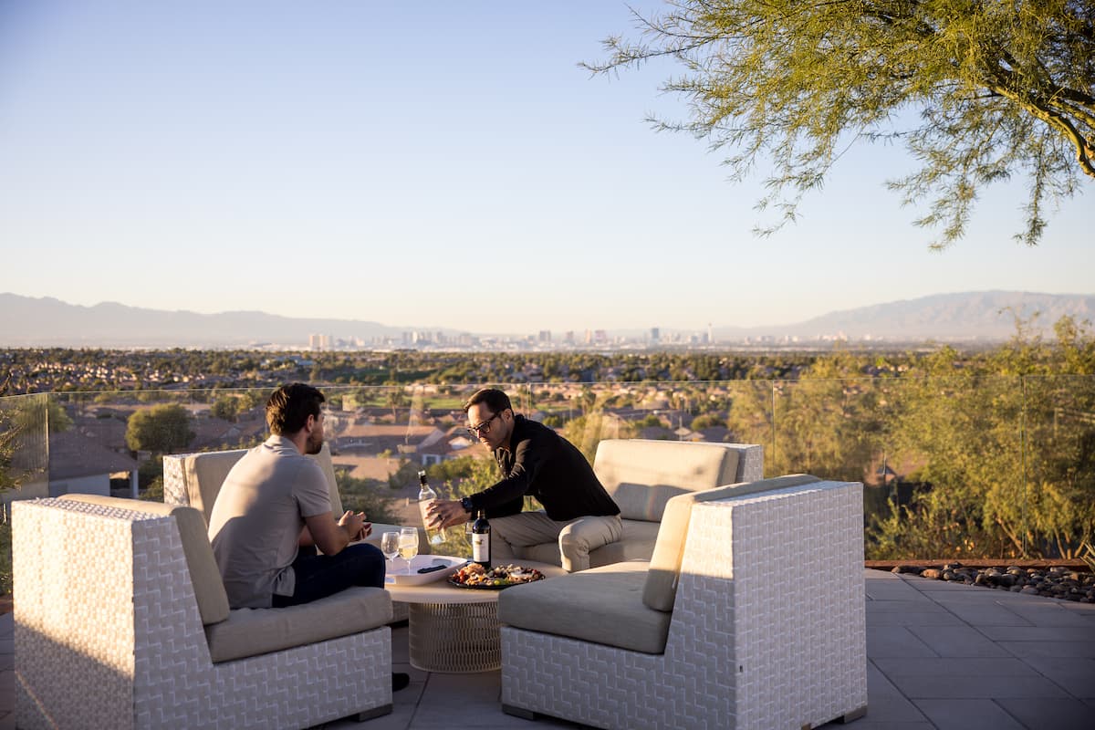 Outdoor patio seating overlooking Las Vegas valley at sunset.