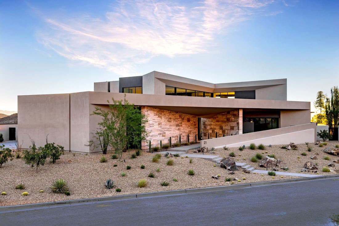 Modern luxury home in Ascaya with contemporary desert architecture, clean lines, and elevated mountain setting at sunset