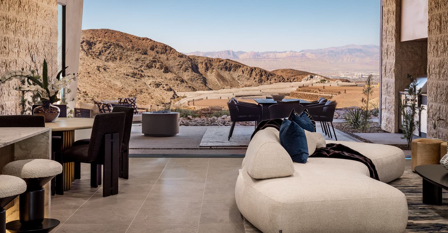 Luxury open-concept living space with desert mountain views, modern furnishings, and seamless indoor-outdoor design.
