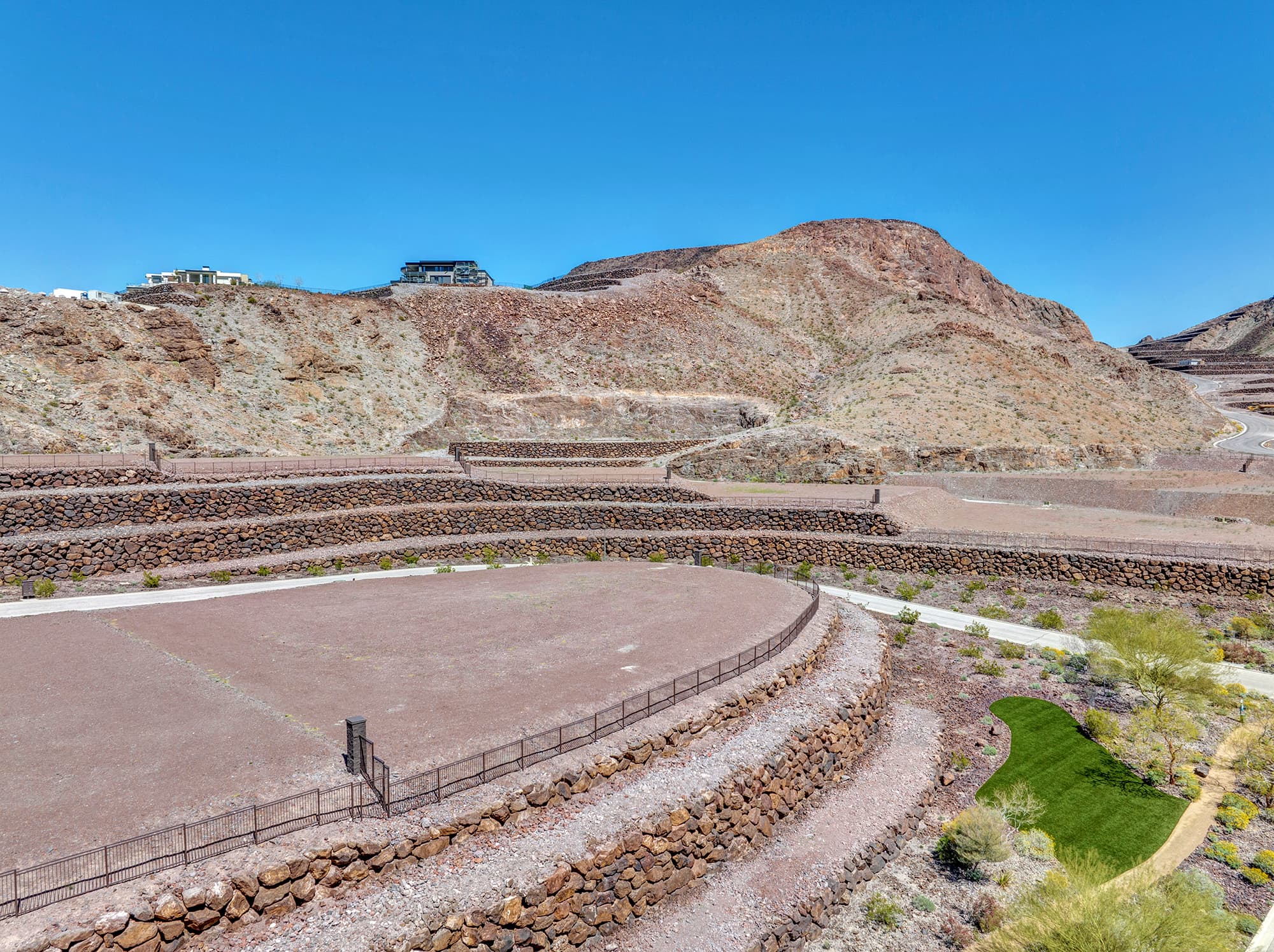 Aerial view of homesite lot outlined within a desert mountainside community development