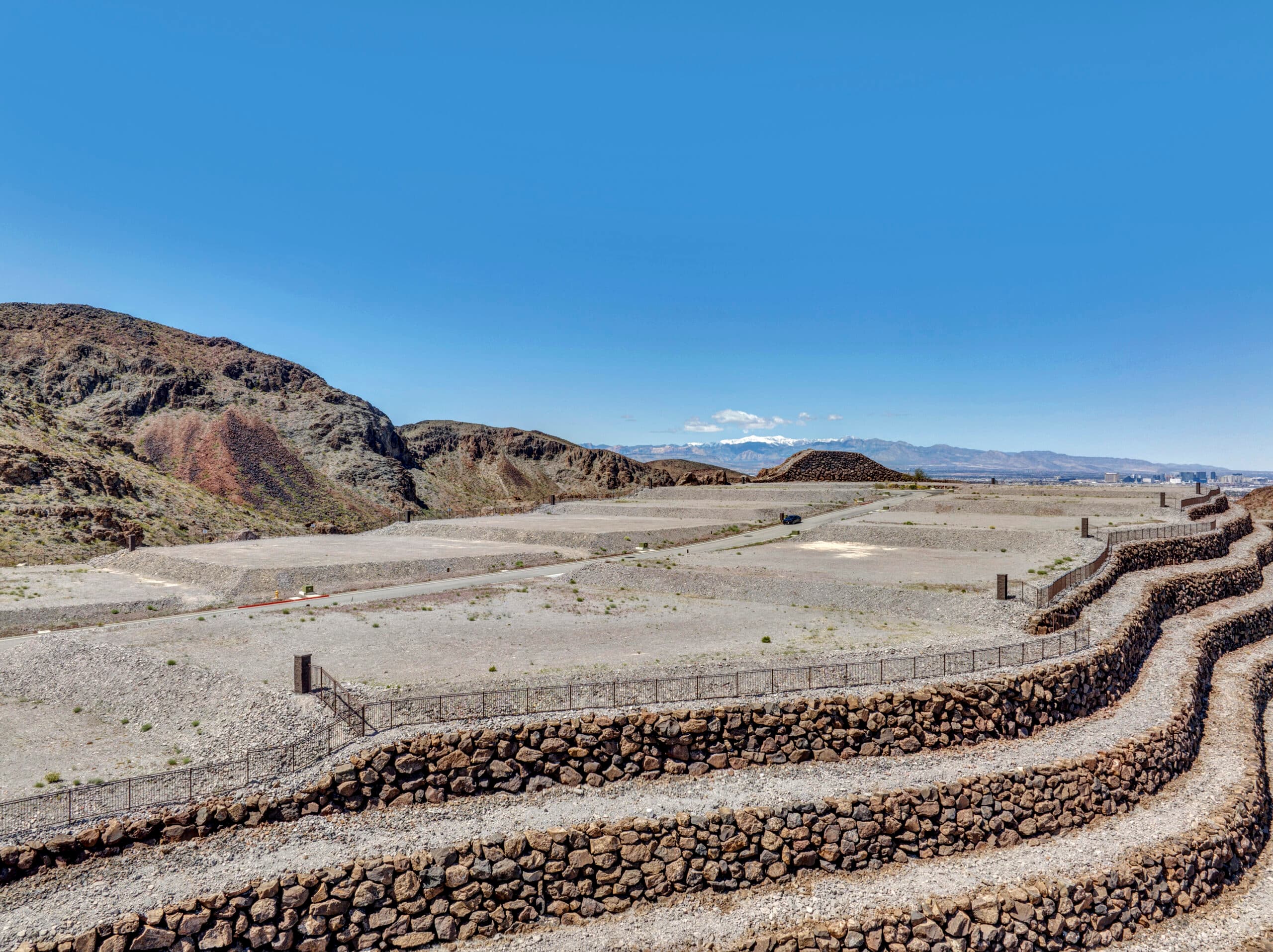 Elevated custom homesite with terraced retaining walls and dramatic desert mountain views in a luxury Las Vegas residential community.