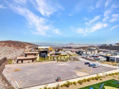 Aerial view of homesite lot outlined within a desert mountainside community development