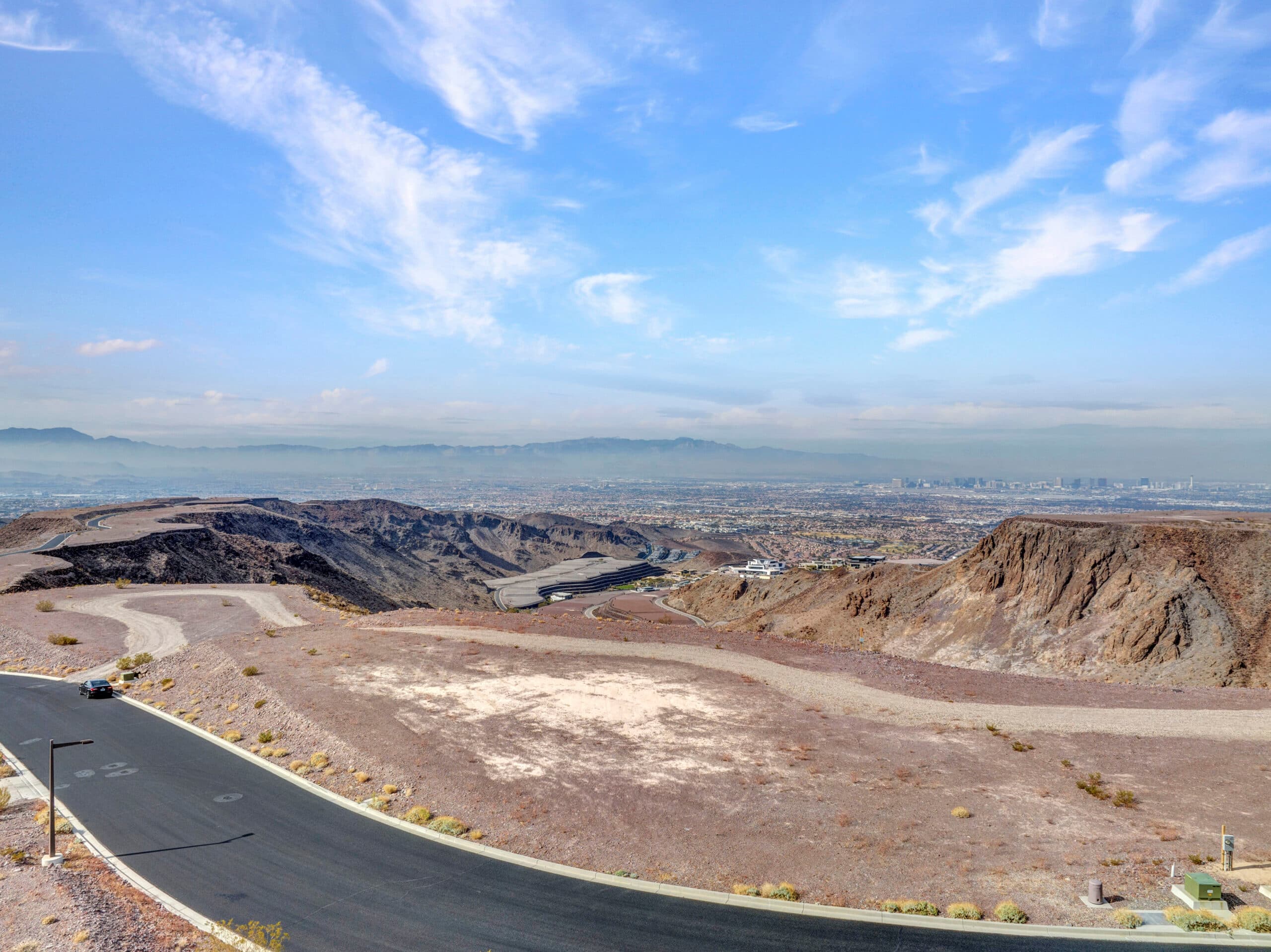 Panoramic Las Vegas Strip and mountain views from a premium desert hillside homesite in an exclusive luxury community.