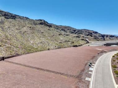 Aerial view of homesite lot outlined within a desert mountainside community development