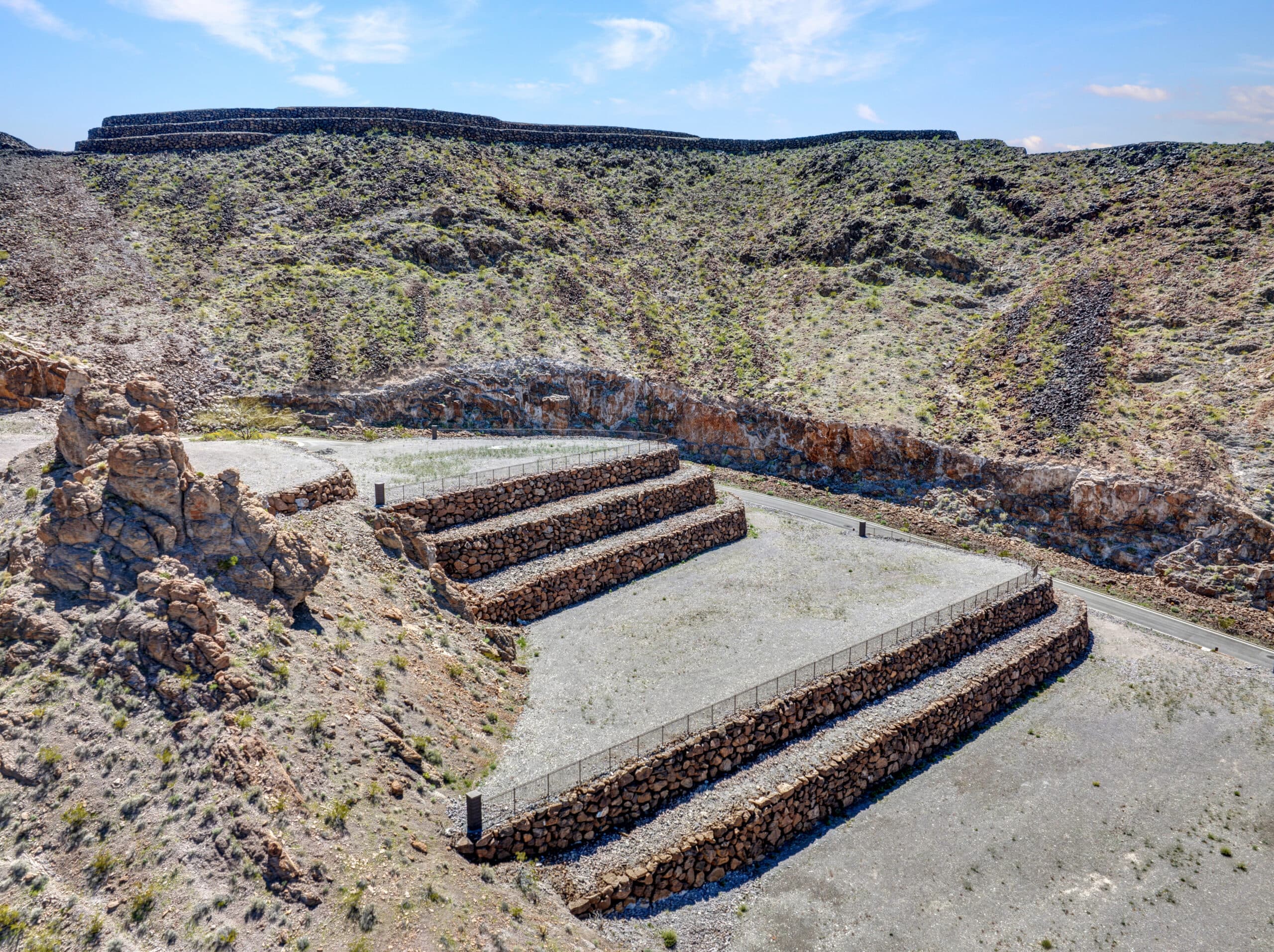 Terraced luxury homesite with stone retaining walls in desert hillside community near Las Vegas.