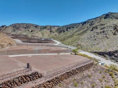 Aerial view of homesite lot outlined within a desert mountainside community development