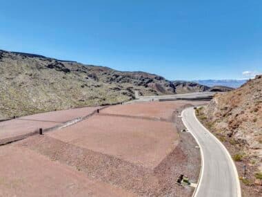 Aerial view of homesite lot outlined within a desert mountainside community development
