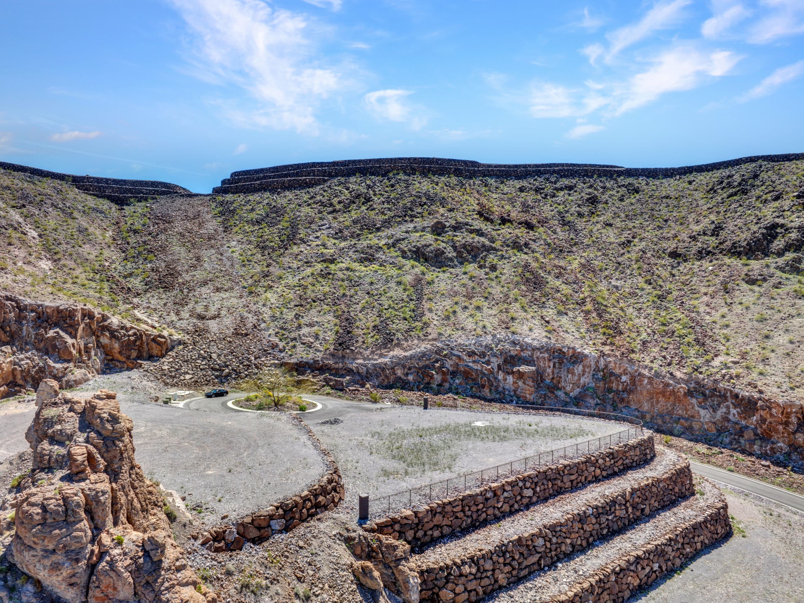 Terraced luxury homesite with stone retaining walls in desert hillside community near Las Vegas.