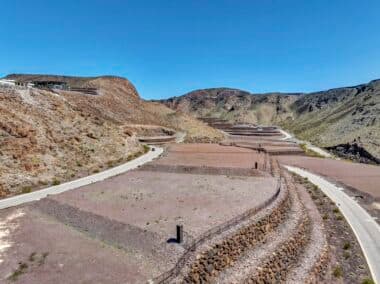 Aerial view of homesite lot outlined within a desert mountainside community development