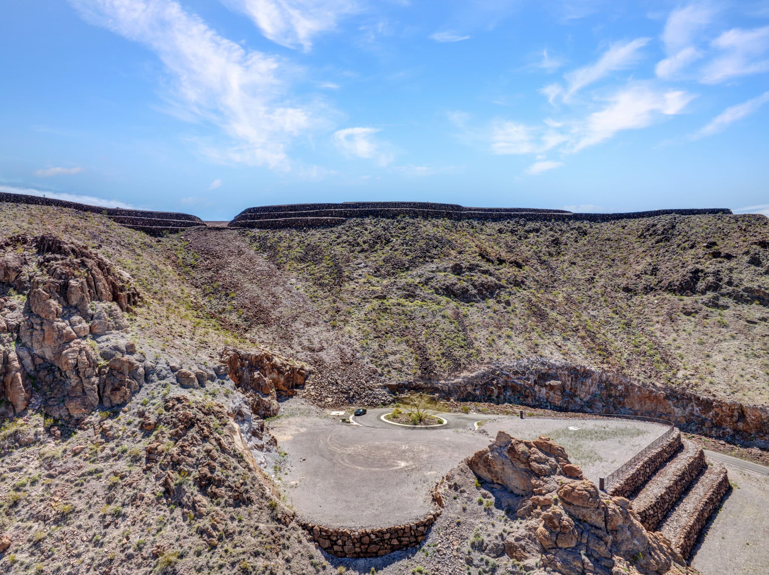 Terraced luxury homesite with stone retaining walls in desert hillside community near Las Vegas.