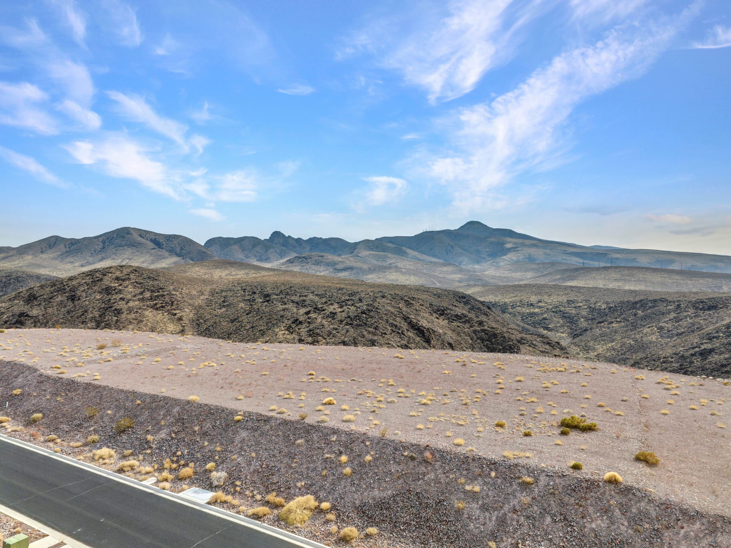 Elevated desert homesite with sweeping Las Vegas valley and mountain views in luxury hillside community.