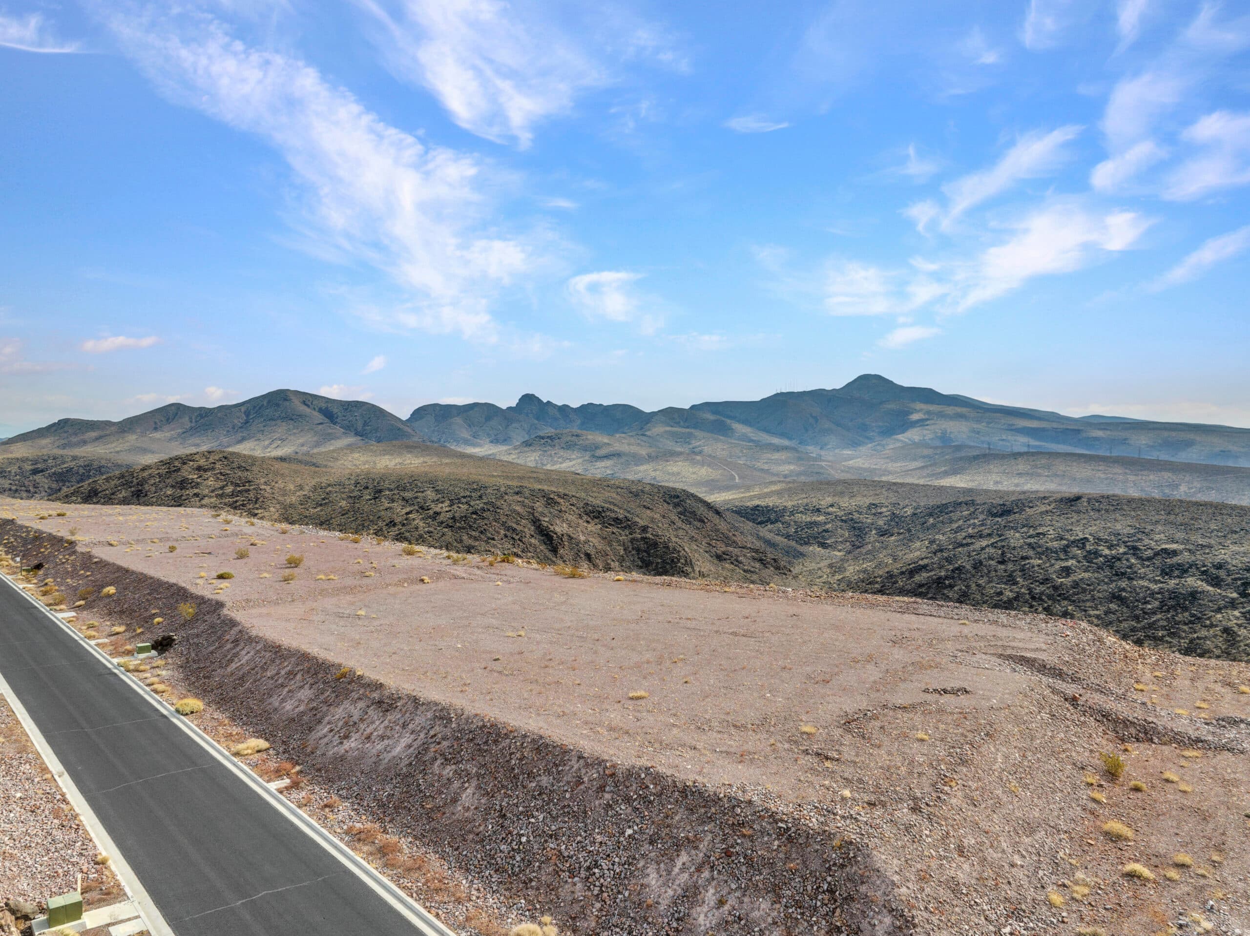 Elevated desert homesite with sweeping Las Vegas valley and mountain views in luxury hillside community.