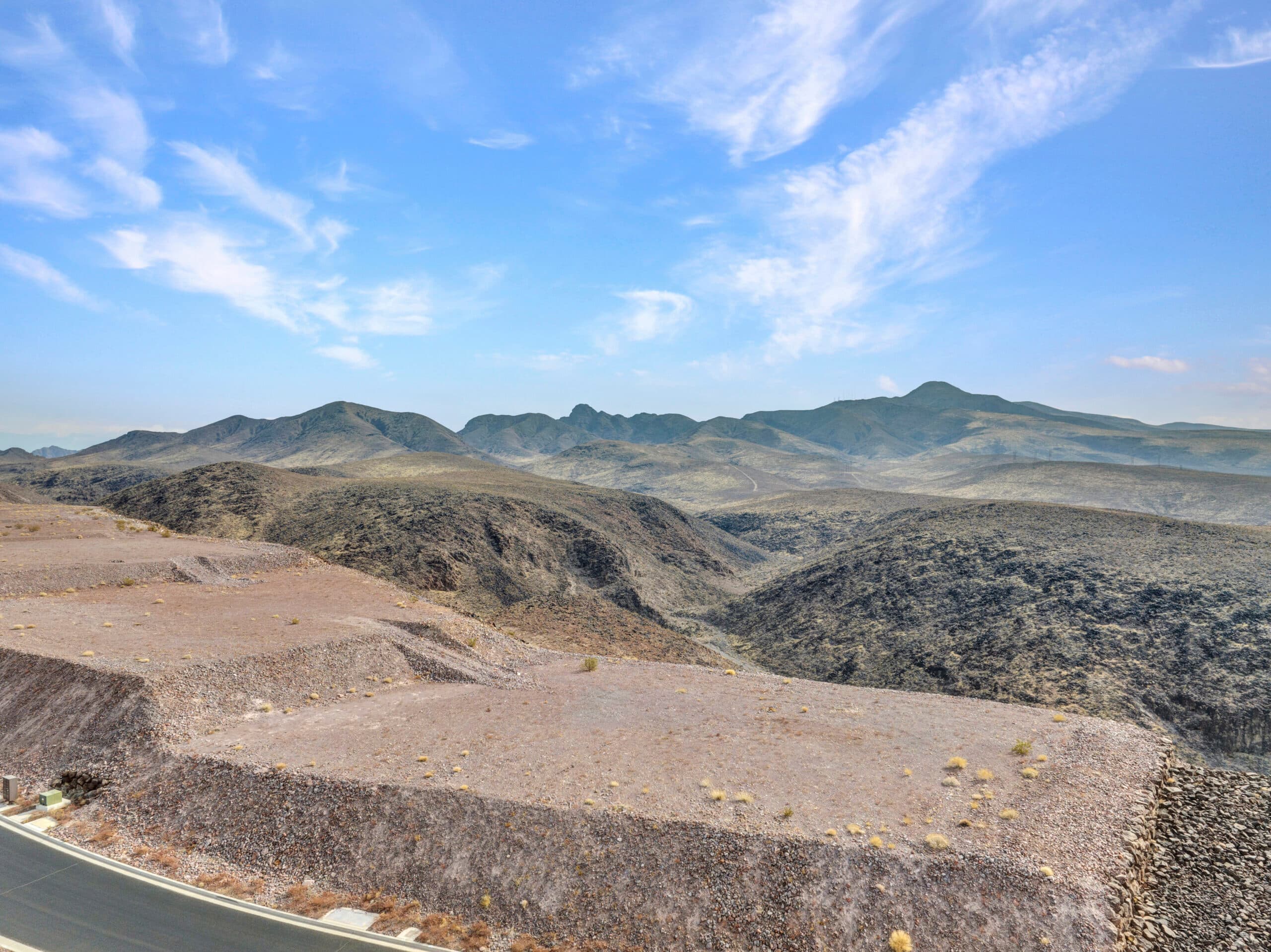 Elevated desert homesite with sweeping Las Vegas valley and mountain views in luxury hillside community.