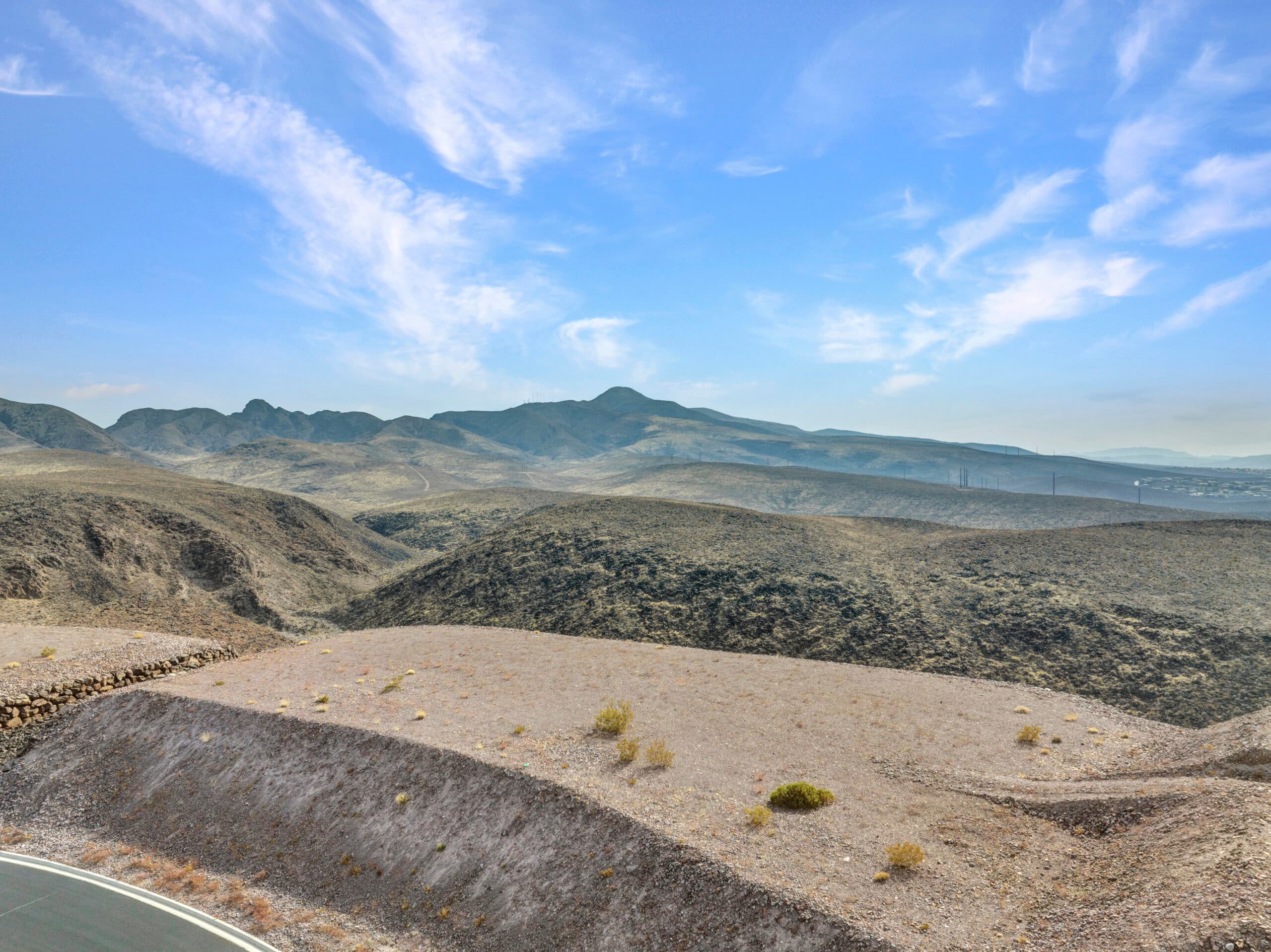 Elevated desert homesite with sweeping Las Vegas valley and mountain views in luxury hillside community.