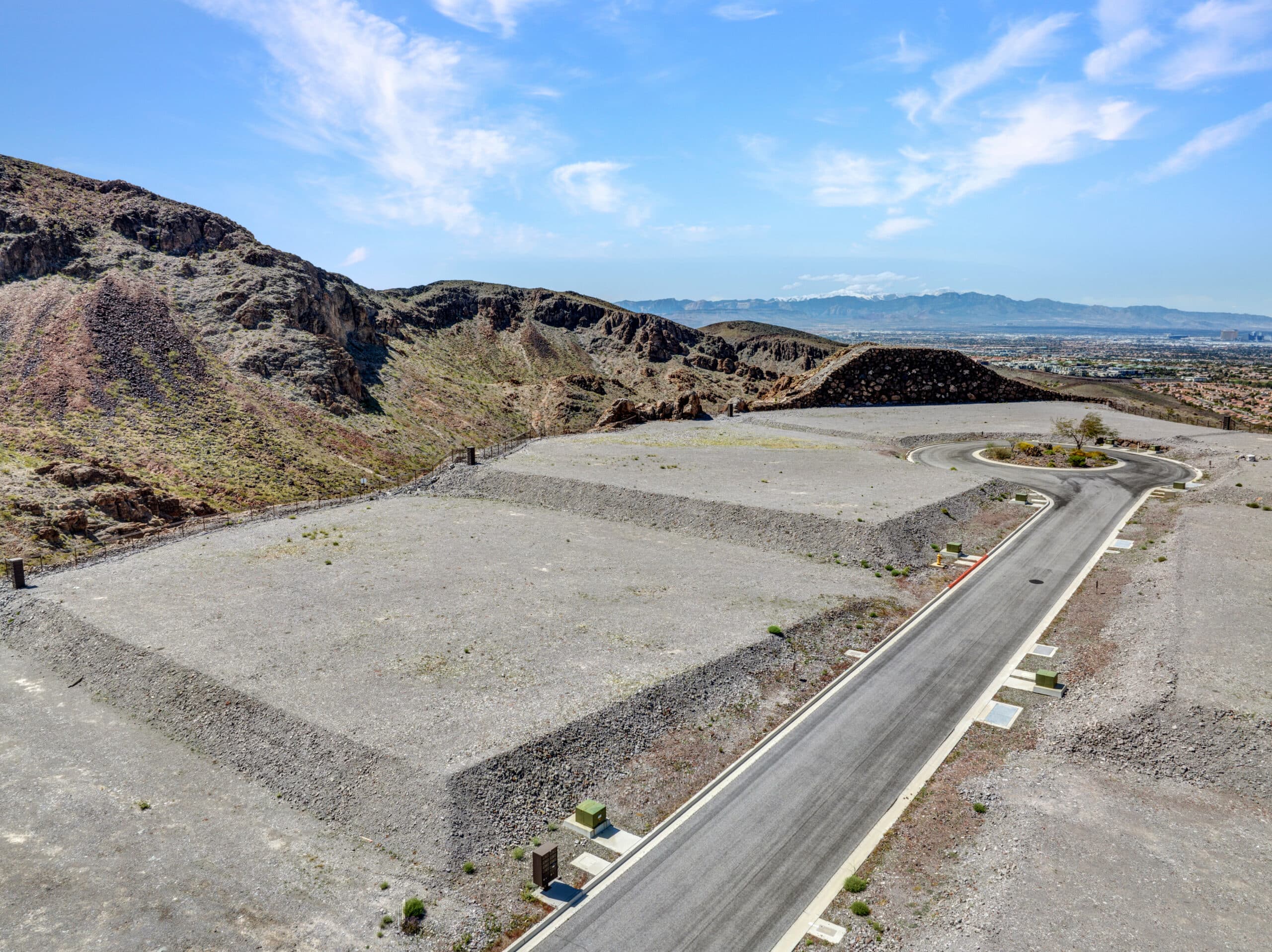 Private canyon-view homesite with terraced desert landscaping and sweeping mountain scenery in an exclusive Las Vegas luxury neighborhood.