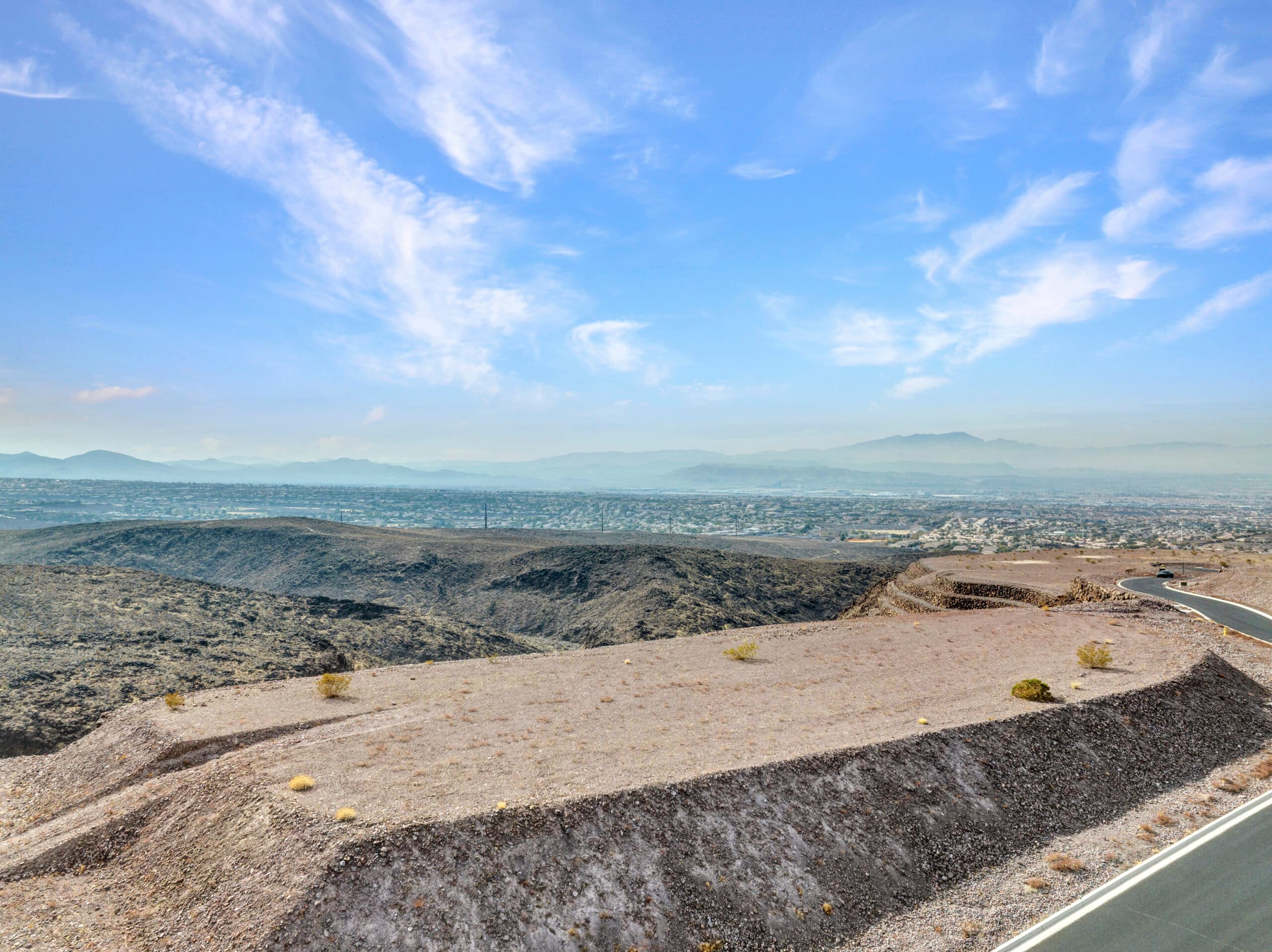 Elevated desert homesite with sweeping Las Vegas valley and mountain views in luxury hillside community.
