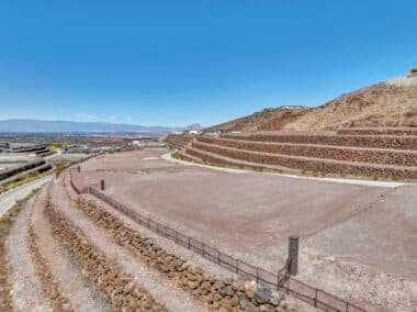 Aerial view of homesite lot outlined within a desert mountainside community development