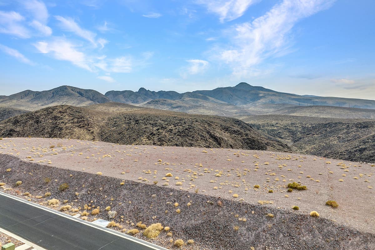 Elevated desert homesite with sweeping Las Vegas valley and mountain views in luxury hillside community.