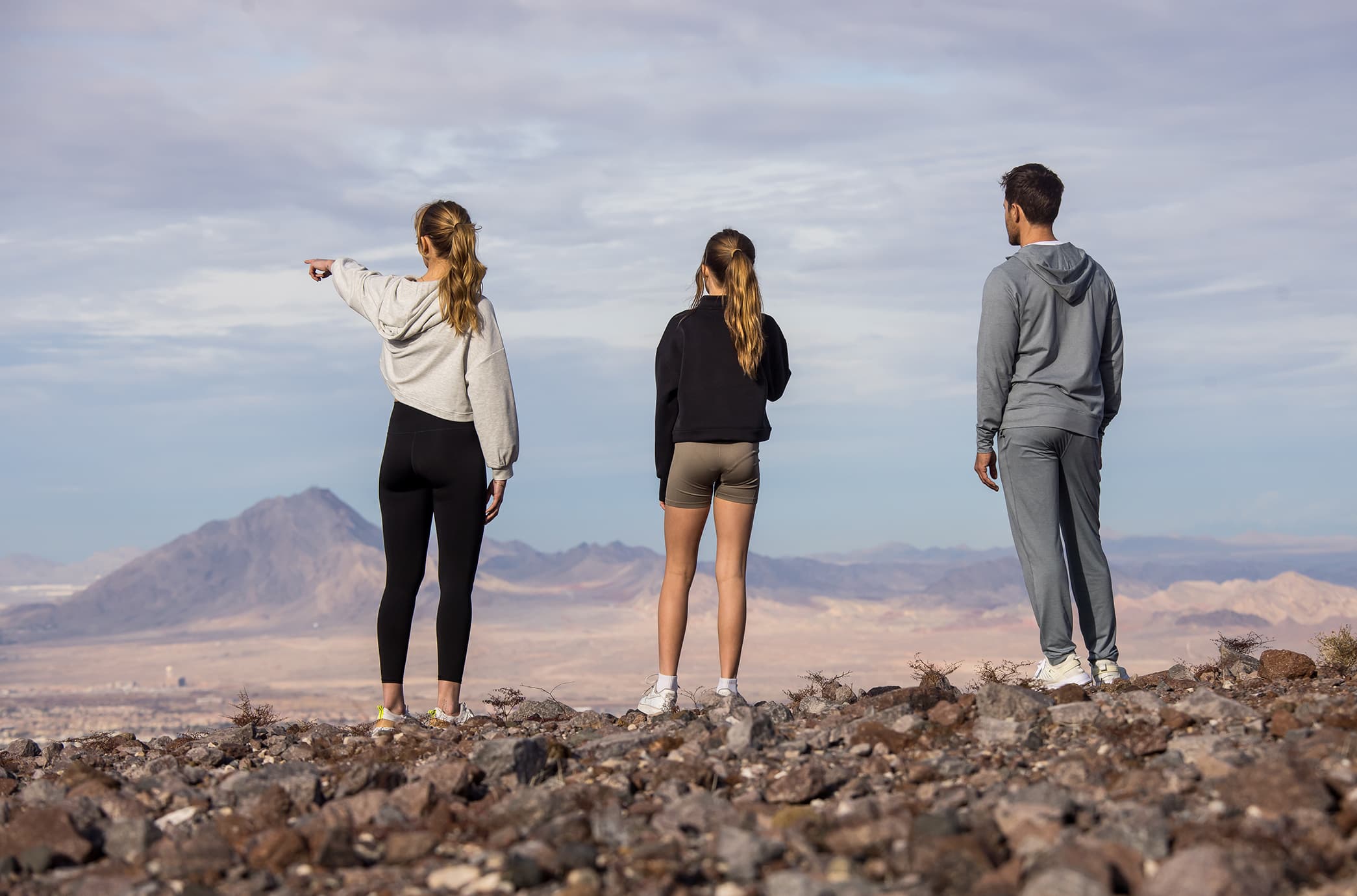 Residents taking in the sweeping landscape beyond Ascaya, standing atop a desert ridge with expansive views of the valley and surrounding mountains.