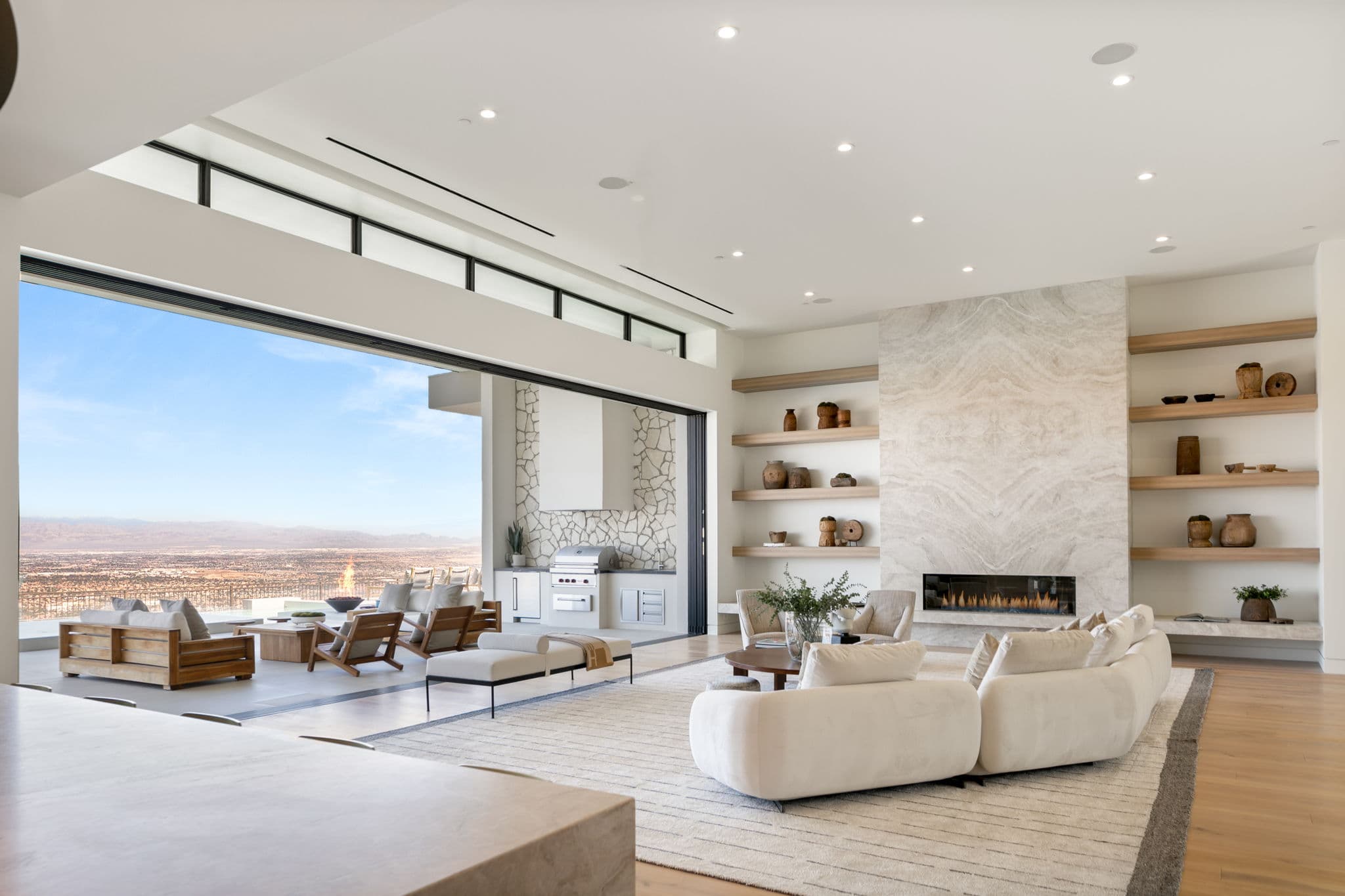 Open-concept luxury living room in Ascaya with indoor-outdoor design and panoramic desert view