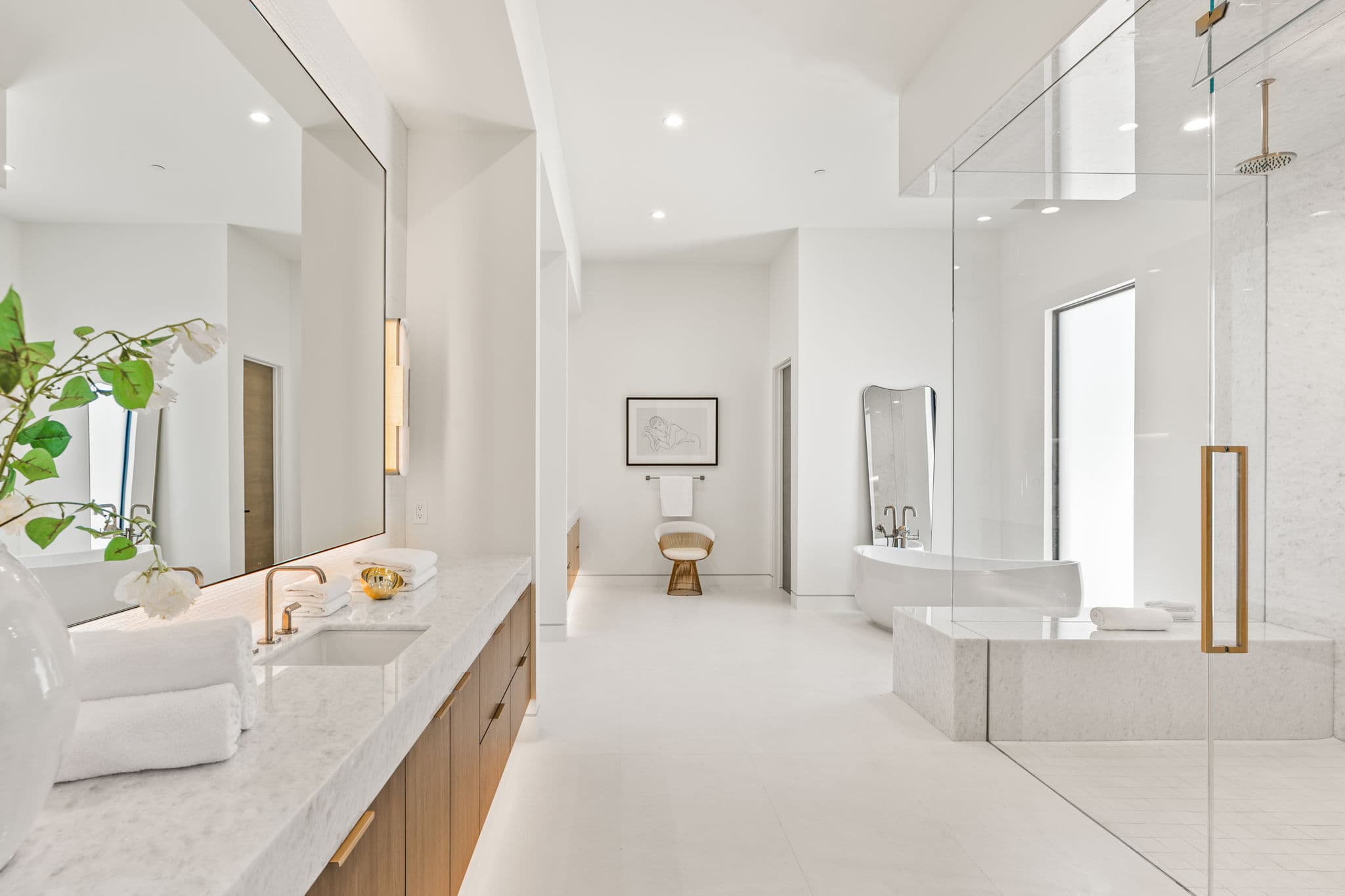 Spa-inspired luxury primary bathroom in Ascaya with freestanding soaking tub, oversized glass shower, and modern minimalist finishes
