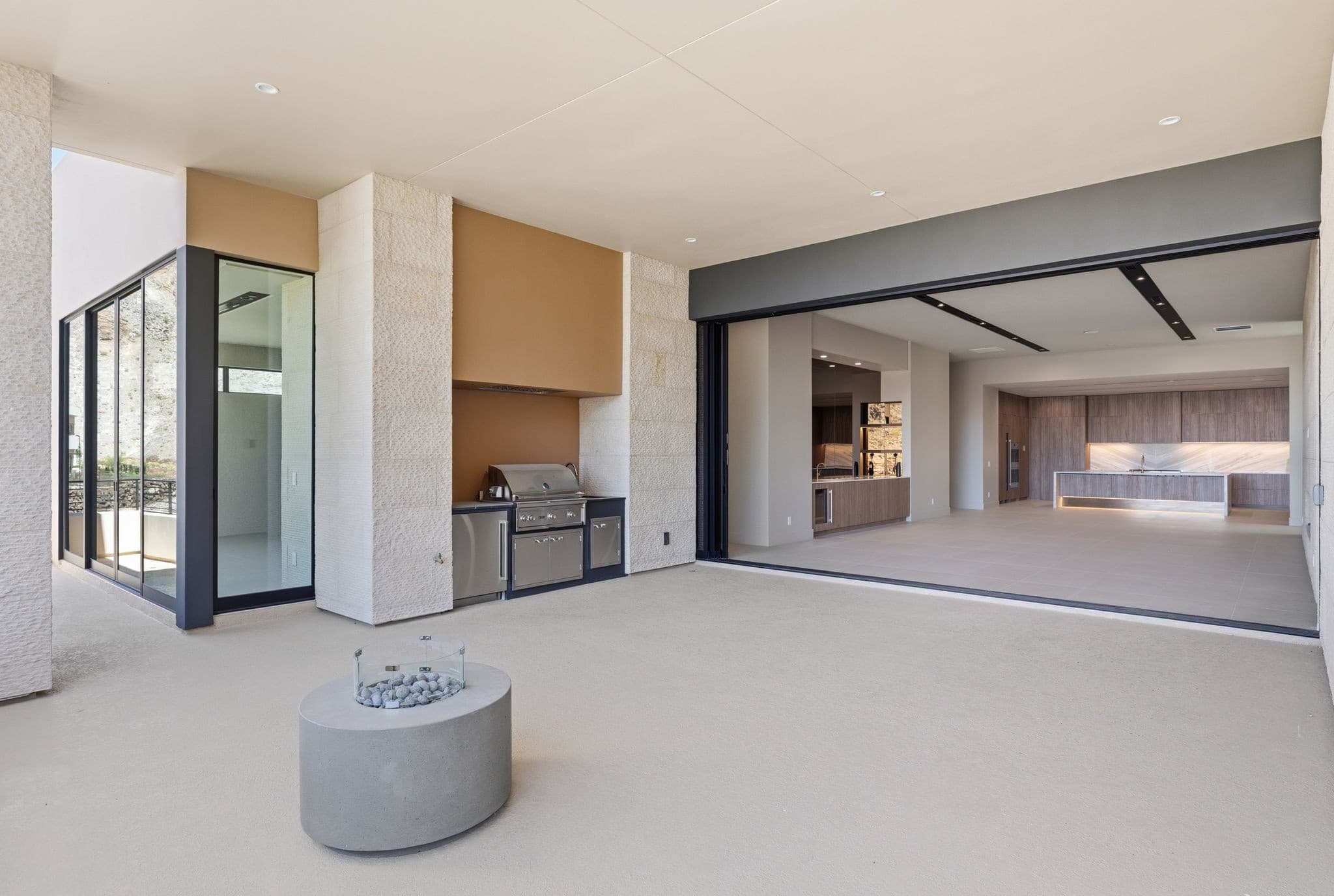 Modern luxury residence with contemporary architecture, open-concept living spaces, high-end finishes, expansive windows, and seamless indoor-outdoor design set against scenic desert mountain views.
