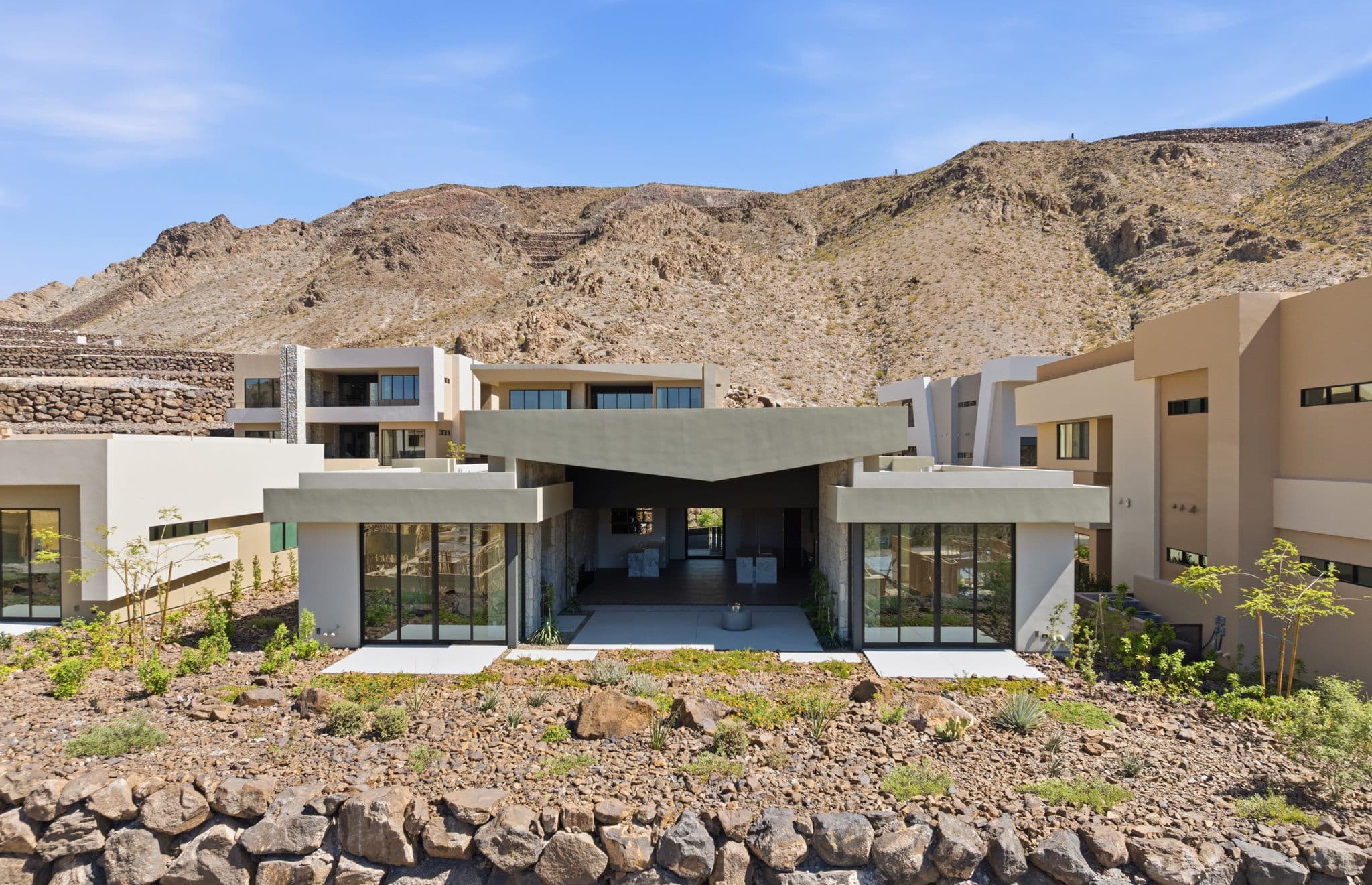 Modern luxury residence with contemporary architecture, open-concept living spaces, high-end finishes, expansive windows, and seamless indoor-outdoor design set against scenic desert mountain views.