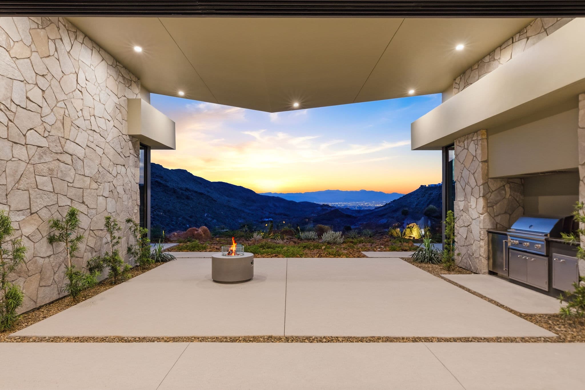 Modern luxury residence with contemporary architecture, open-concept living spaces, high-end finishes, expansive windows, and seamless indoor-outdoor design set against scenic desert mountain views.